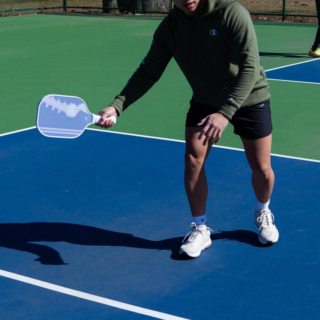 A detailed image depicting a variety of advanced pickleball paddles, featuring innovative designs and high-tech materials. Each paddle is individually presented, with a focus on unique attributes such