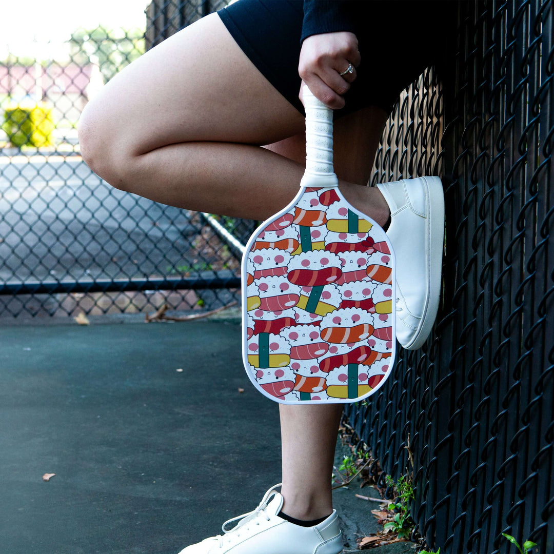 A detailed illustration of a pickleball paddle, highlighting various parts and their respective purposes. The sports equipment is showcased against a background that exudes simplicity to draw focus on