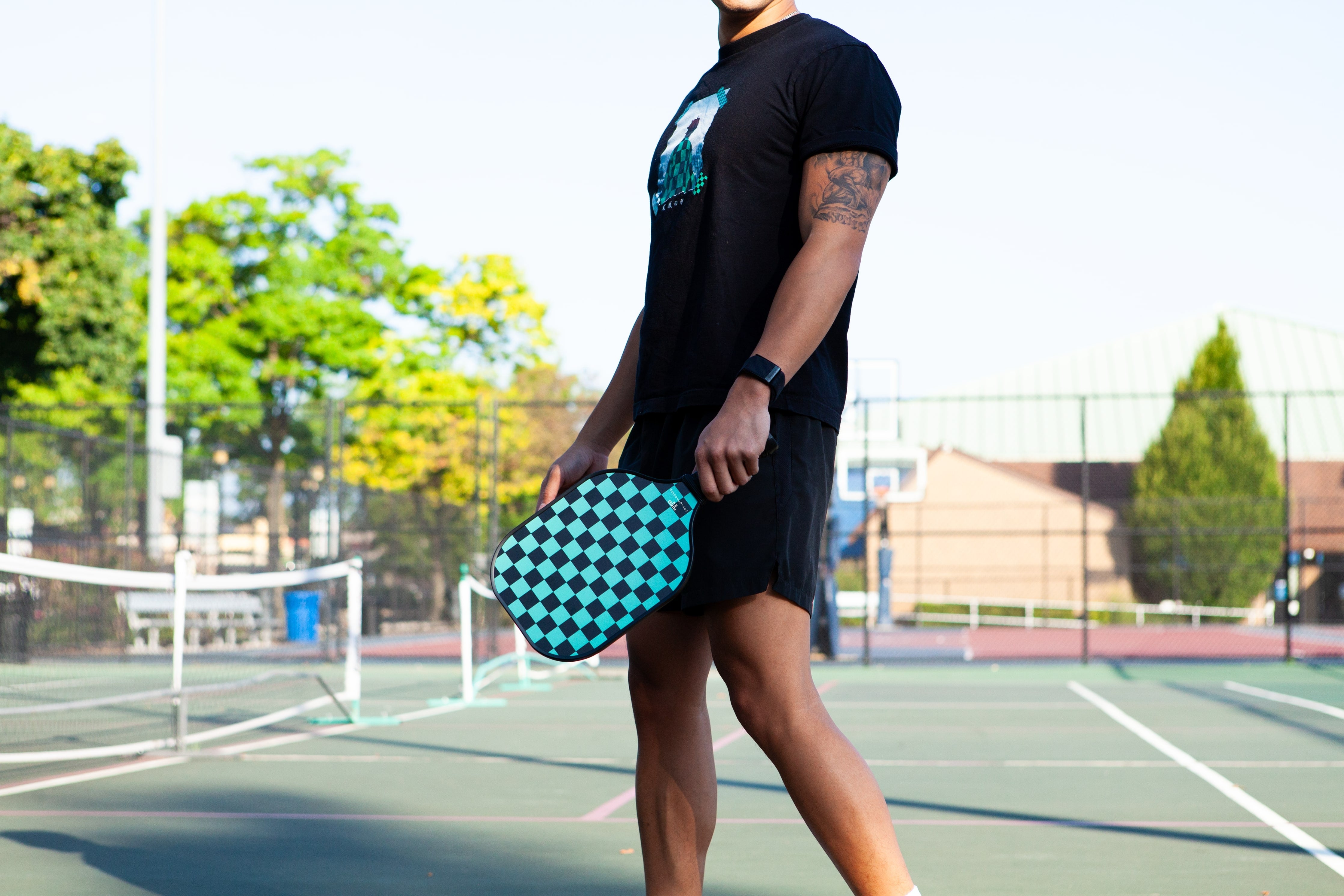 Man holding a tanjiro pickleball paddle from TokyoPaddles.