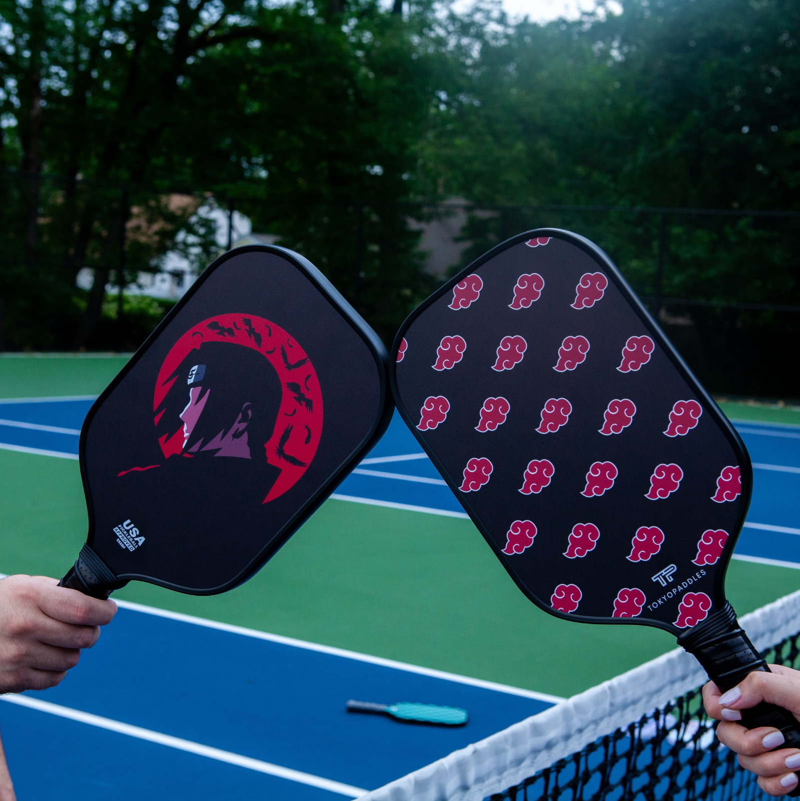 Two carbon fiber pickleball paddles made by TokyoPaddles. Itachi pickleball paddle on the left, Akatsuki pickleball paddle on the right.